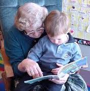 photo of woman reading to boy